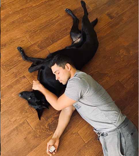 Wilmer Valderrama sleeping with holding his pet.